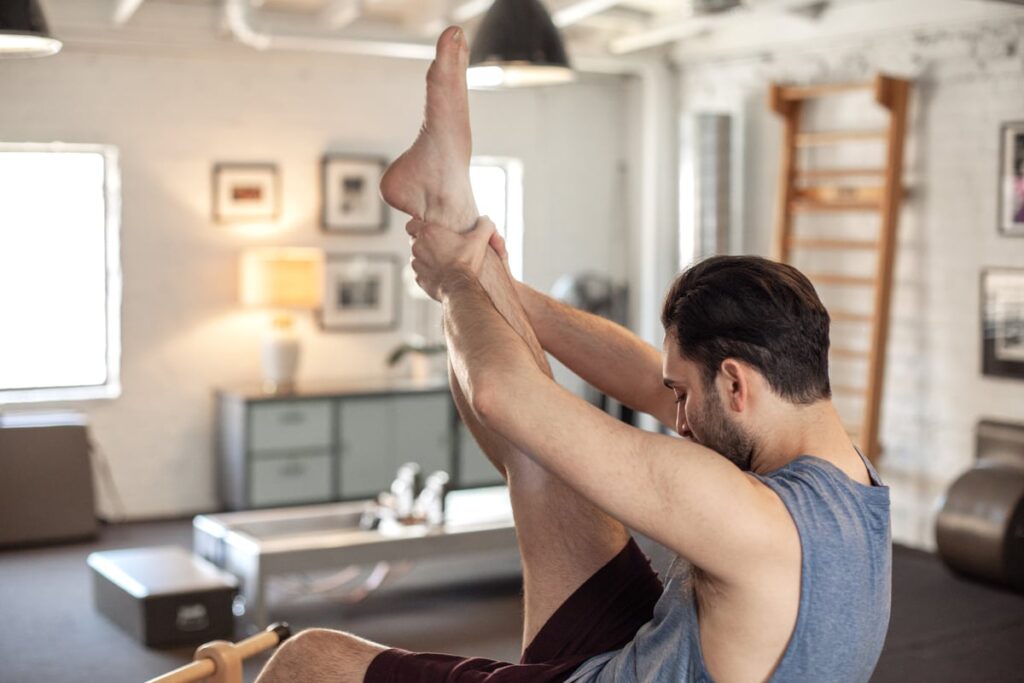 Person exercising on Contrology Ladder Barrel in Pilates studio.