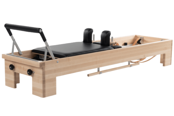 CenterLine Reformer for Pilates studios, wooden frame and leather straps.