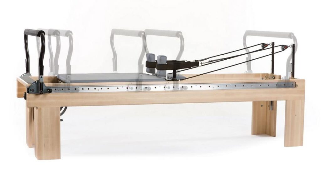 Infinity Footbar ir reguliuojama Revo Springbar sistema ant Pilates reformerio.