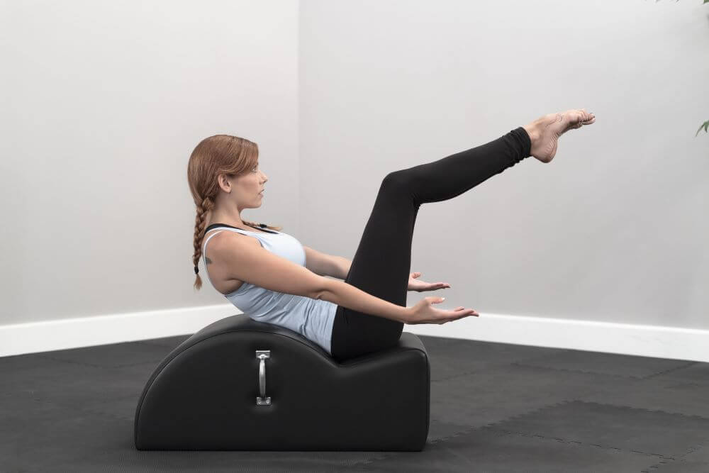 Person exercising on East Coast Step Barrel for Pilates training.
