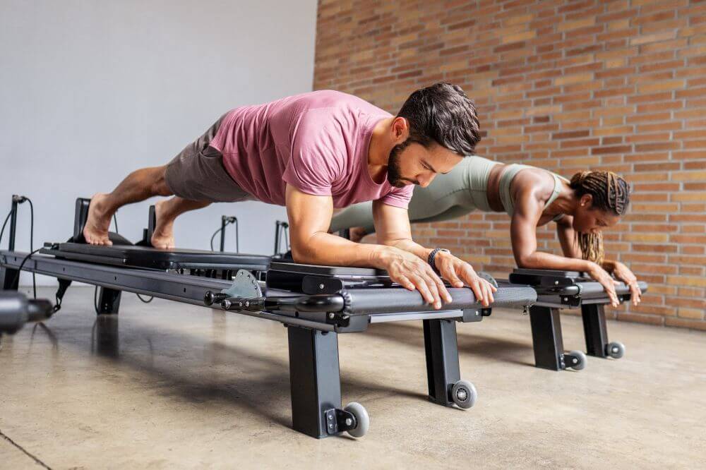Pilates enthusiasts using Allegro NextGen Standing Platform Extender.